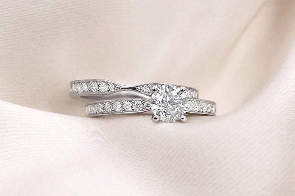 Matching round diamond and pavé tapered band engagement ring and wedding ring set