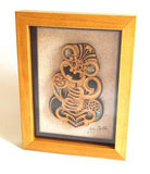 framed maori tiki carving