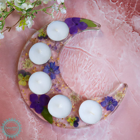 resin candle holder made of preserved flowers with space for tea light candles (5) in the shape of a moon.