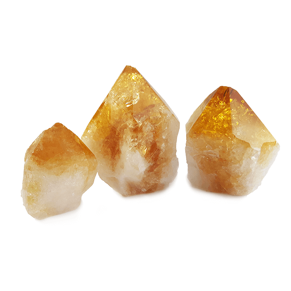 three pieces of citrines crystals on white background close up view