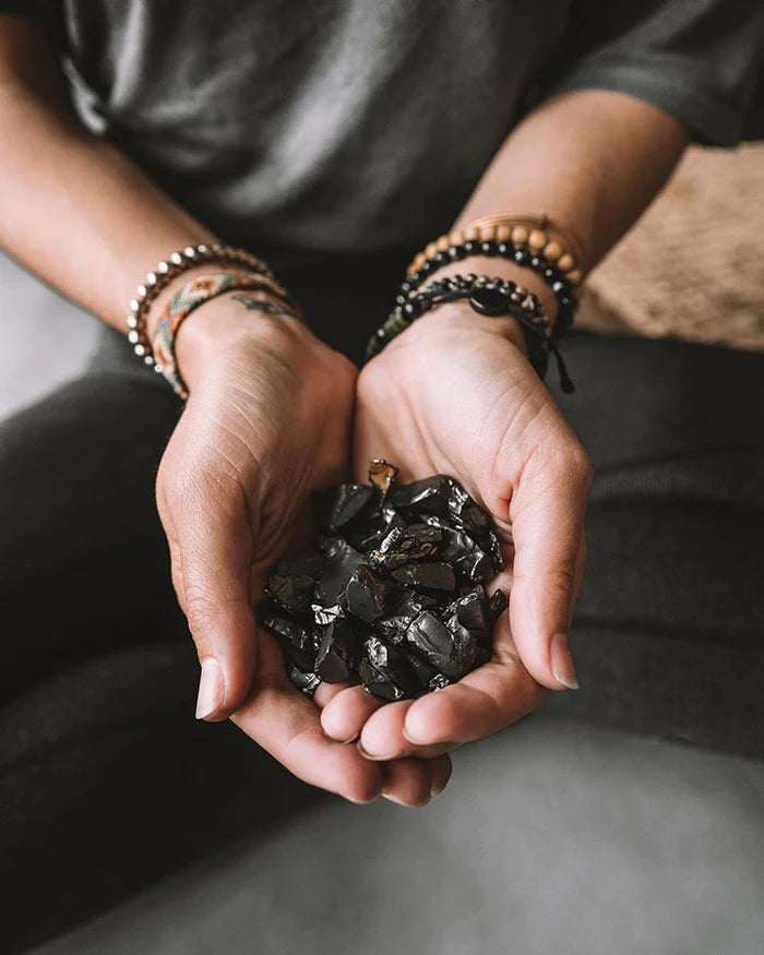 hands carrying shungite
