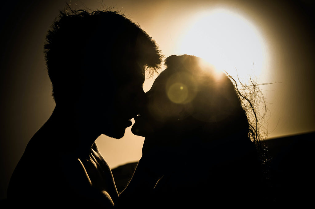 a man and woman kissing passionately