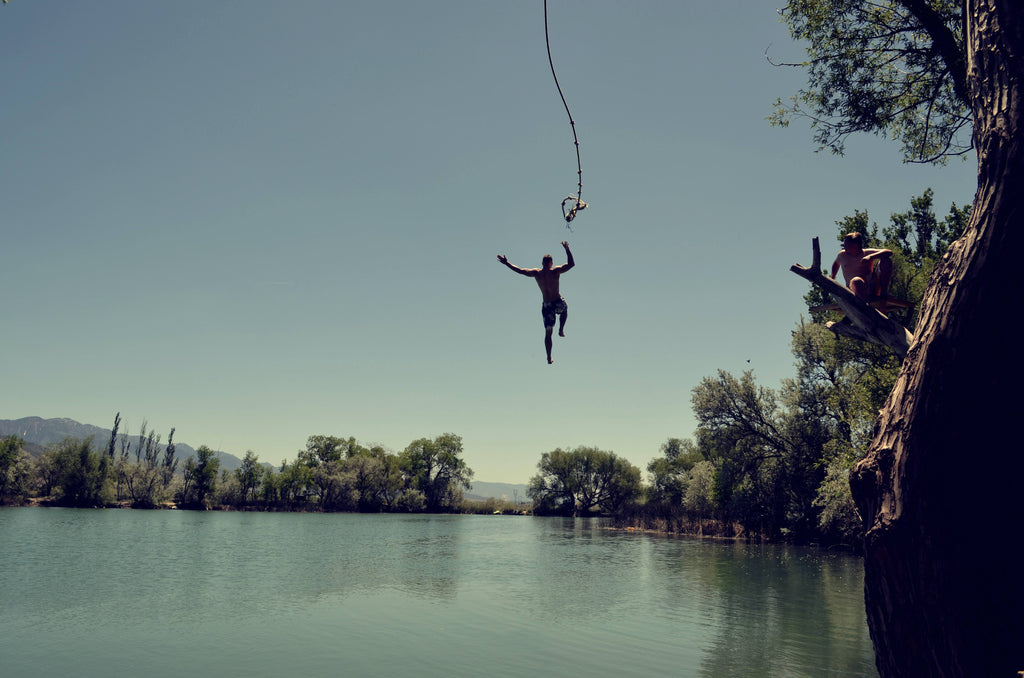 a man jumping on a lake