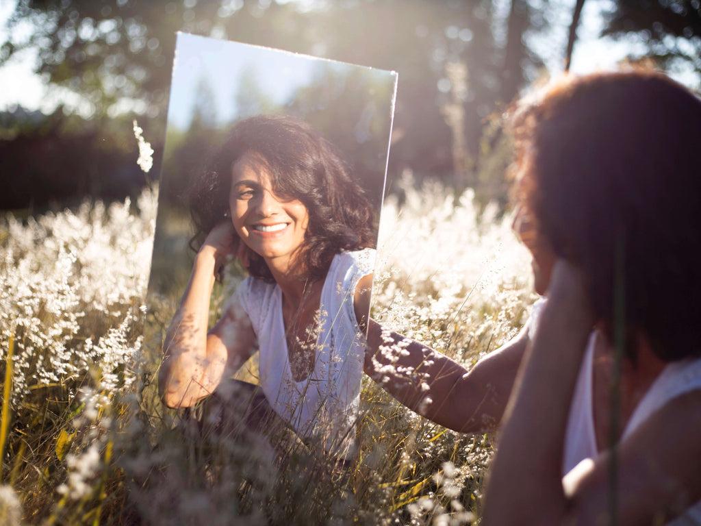 a happy girl's reflection in the mirror