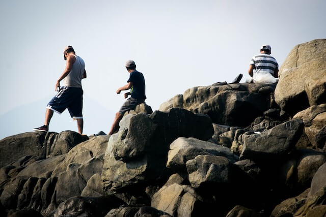 a group of men on rocks