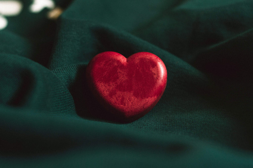 a red heart on a green cloth