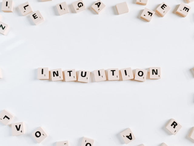 the word intuition on letter tiles