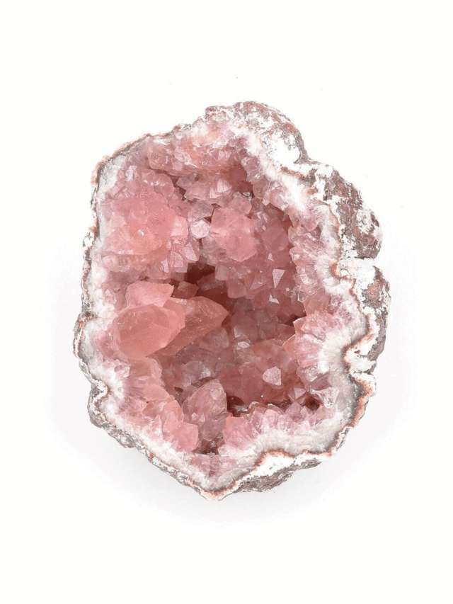 raw pink geode crystal close up view white background