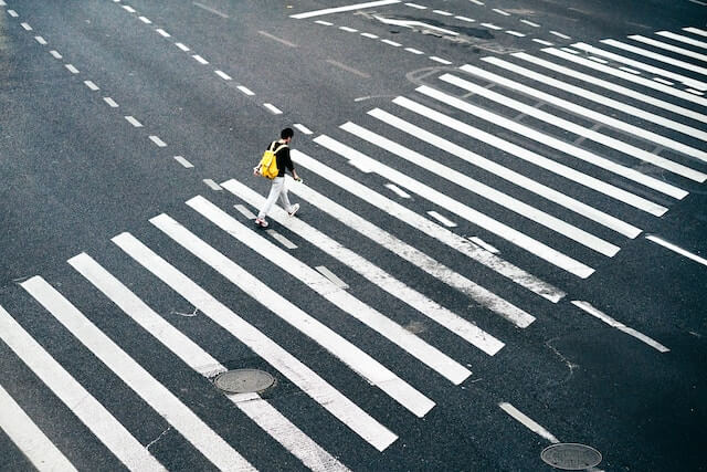 person walking on a pedestrian lane