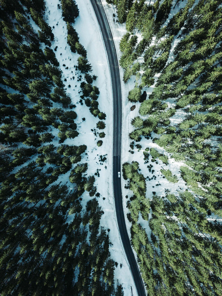 aerial shot if a vehicle on a snowy road
