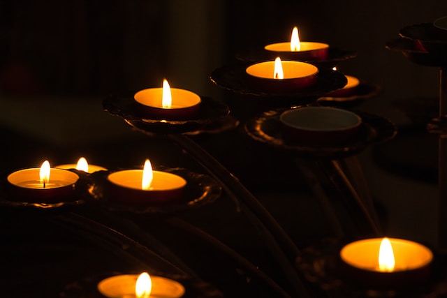 lighted candles on black metal cannisters