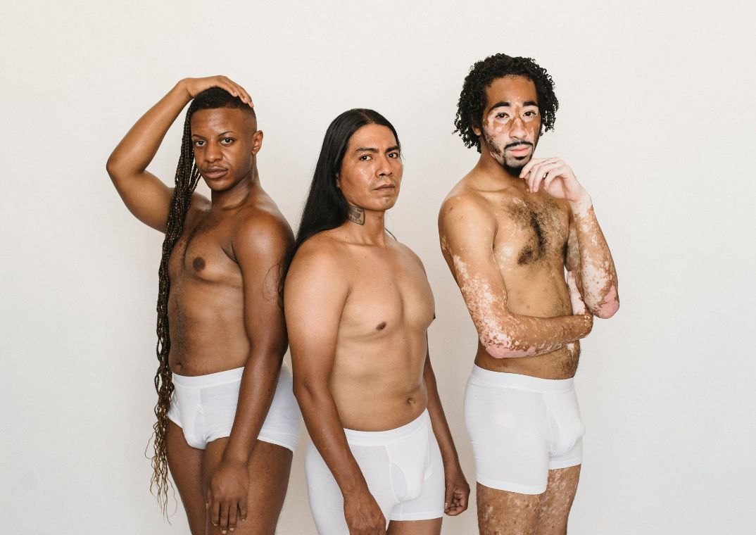 three diverse men wearing white boxer shorts