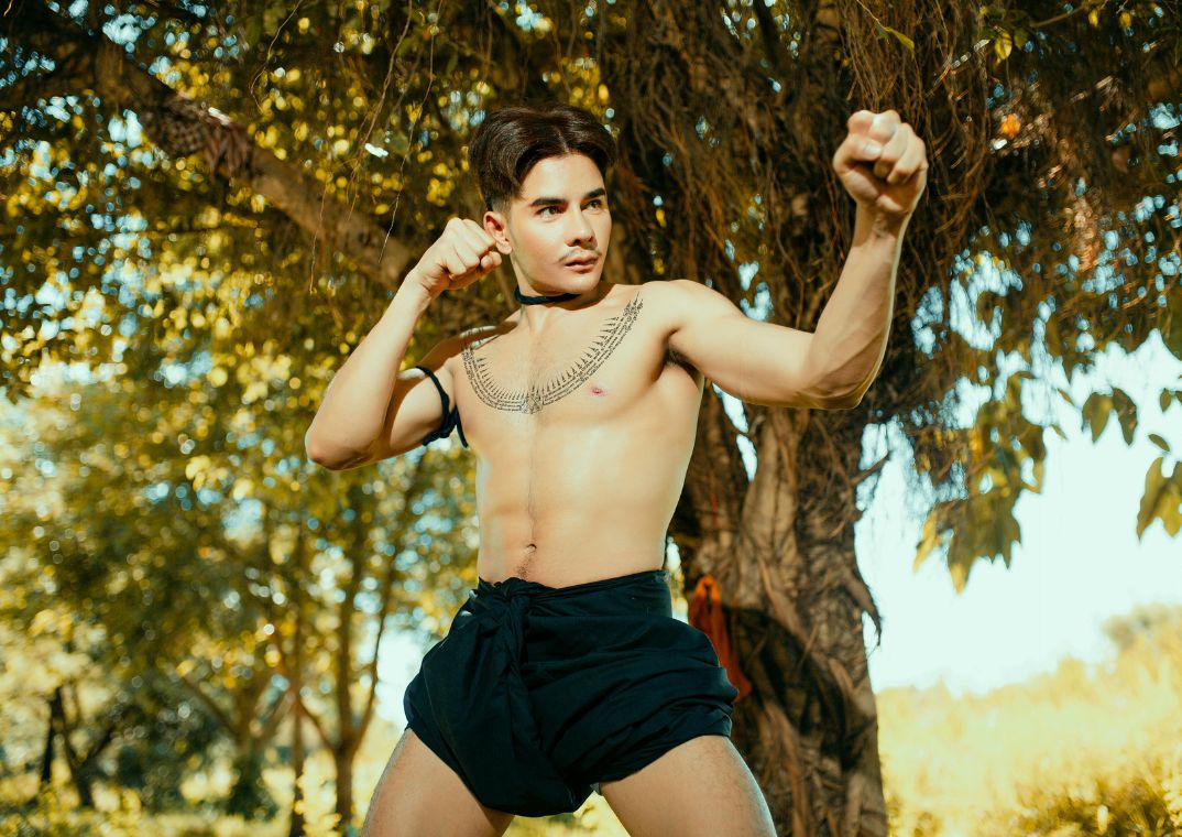 younger man wearing boxers in fighting pose