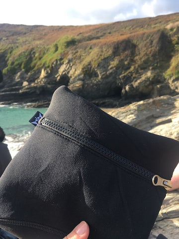 Balance square neoprene pouch in black at Piskies cove beach in Cornwall whilst snorkelling.