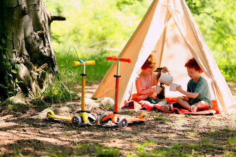 Two kids camping with Micro Scooters