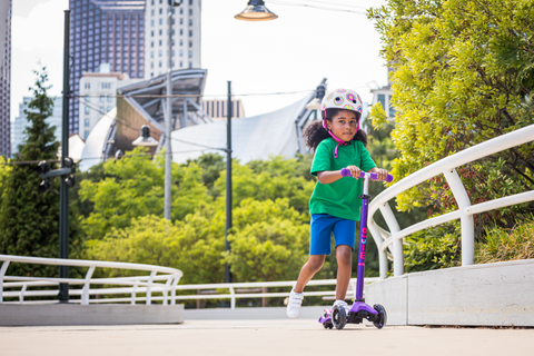 Girl riding Purple Micro Maxi Deluxe LED Scooter