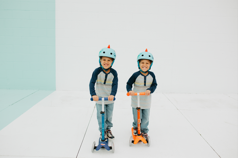 Twin Boys Riding Micro Mini Scooters