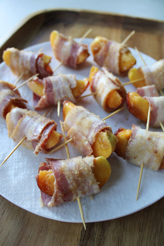 Wrap peaches with bacon slices, roll in brown sugar, and secure with toothpick