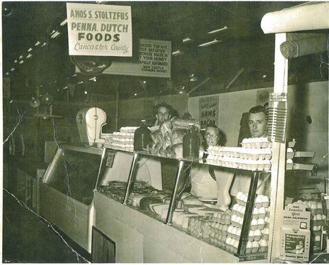 Amos (with hat) and the original Stoltzfus Meats market stand at New Castle, DE