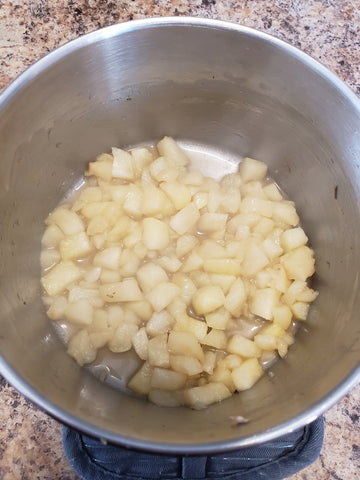cut apples in a cooking pot