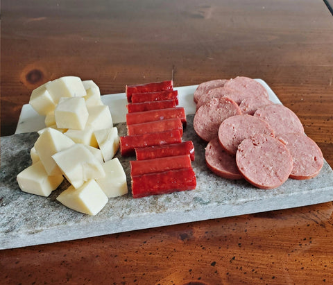 charcuterie board with various meats and cheeses