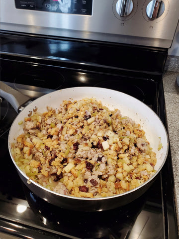 mixing cranberries and stuffing mix to our skillet