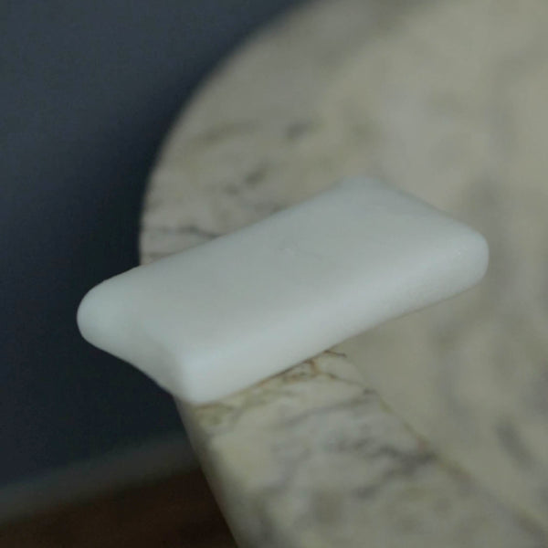 Clothes soap bar sitting on stone sink