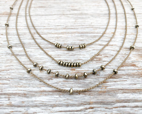 These pyrite stones move along the rope and stay in place so you can wear your necklace many ways.