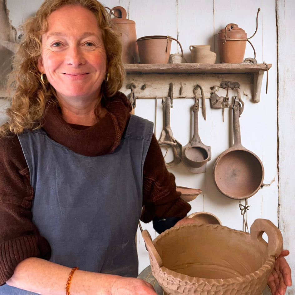 Female pottery student presenting a large fruit bowl in Sabine's pottery studio in Tiverton, Devon.