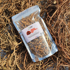 Our Jamaican Sarsaparilla Roots laying in a bed of freshly sun-dried Roots