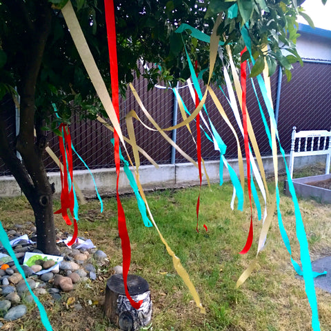 Create a magical space by hanging color streamers and ribbons from a tree.