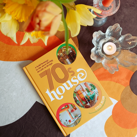 70s house book by Estelle bilson 70s house manchester on table with candles and barbara brown fabric 