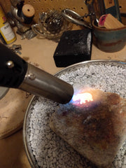 Using a torch on a cleaned piece of gold to melting point