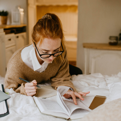 Woman studying Fertility Awareness in her room