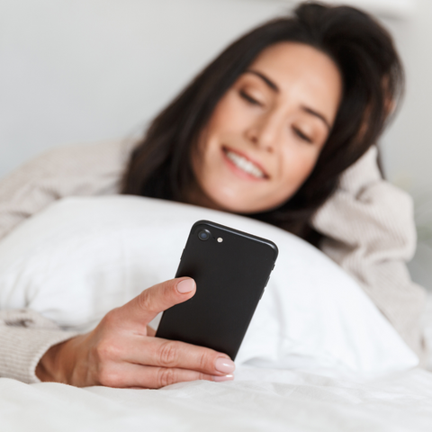 Woman looking at Fertility Awareness app on phone