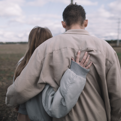 Couple holding each other facing away from the camera