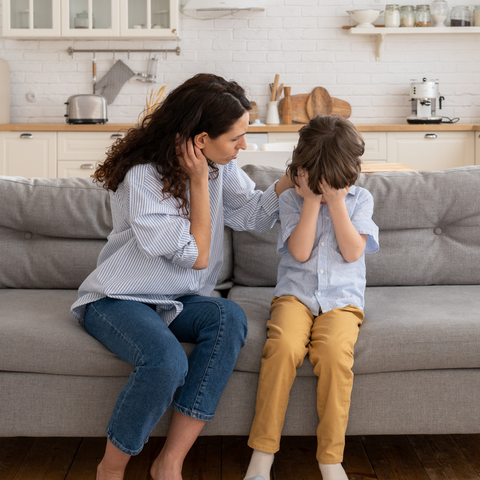 A woman with her child, reassuring them and comforting them