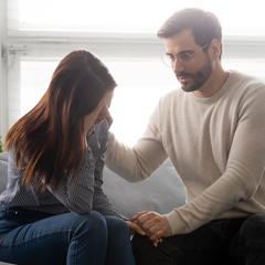 Man comforting his wife through a miscarriage