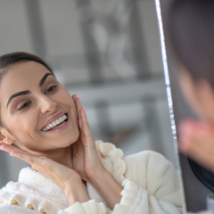 Woman looking at herself in the mirror confidently