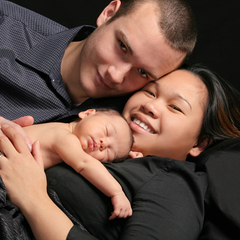 Couple with a baby contact napping on mother's chest