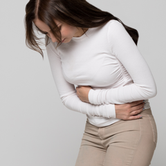 Woman hunched over with intense period pain