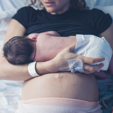 Woman breastfeeding newborn