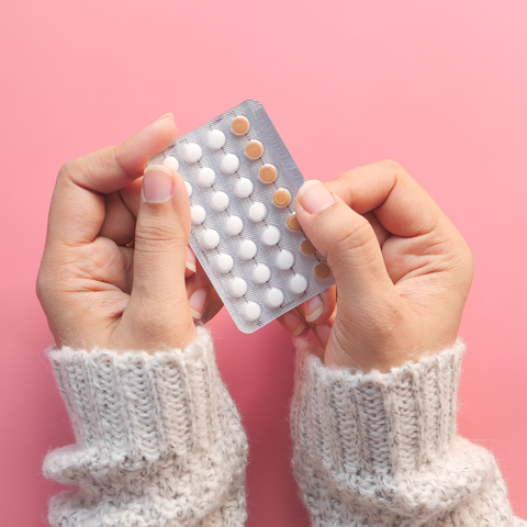woman holding hormonal birth control pack