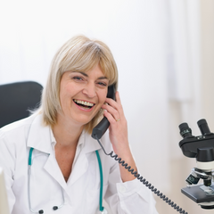 Woman doctor holding a telephone to her ear