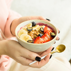 Woman holding a bowl with healthy fruits