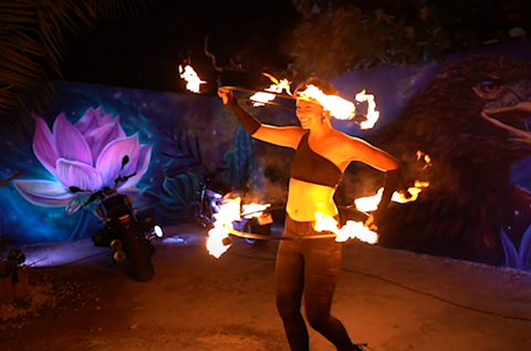 a person spinning a hula hoop that is on fire