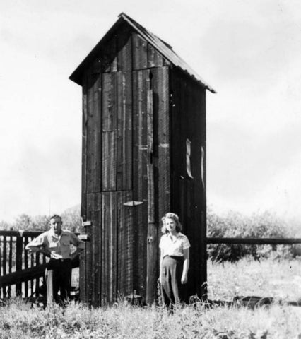 a double decker outhouse from the 1950s