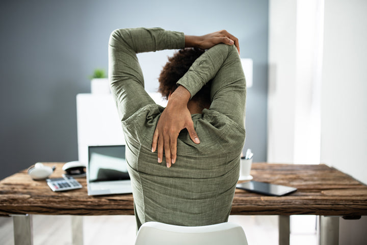 Woman stretching at work for stress relief 