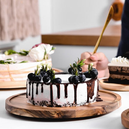 Opened Acacia Dessert plate with a white glazed chocolate cake.