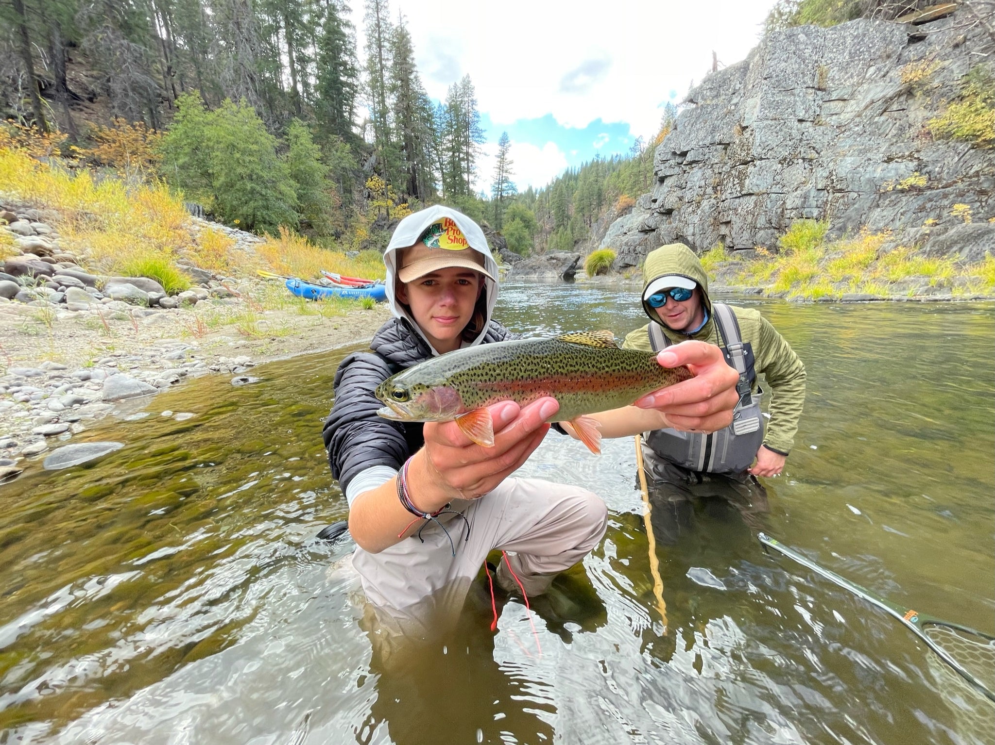 Catching a rainbow trout with a fly rod while on a packrafting trip